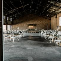 The main hall at Annerkant Venue set with round tables and chiavari chairs