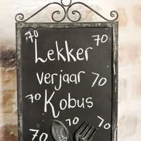 Hand-lettered chalkboard welcoming guests to a birthday celebration